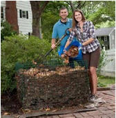 A man and woman raking leaves